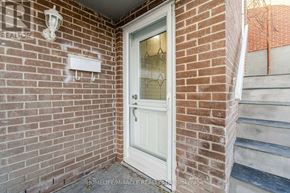 Brampton (Brampton North) apartment for rent - A white door with a glass window is on a brick wall.