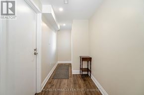 Brampton (Brampton North) apartment for rent - A hallway with a door on the left and a table on the right.