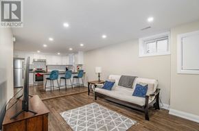 Brampton (Brampton North) apartment for rent - A living room with a couch, chairs, and a television.