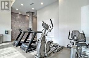 Toronto (Bayview Village) condo for rent - A gym with a row of treadmills and exercise bikes.