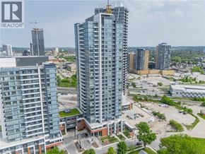Kitchener condo for rent - A cityscape with a large building in the foreground and a REALTOR® logo in the corner.
