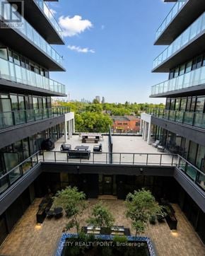 Toronto (Annex) condo for rent - A view from above of a courtyard surrounded by buildings with trees and benches.