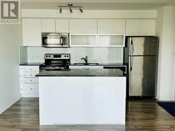 Toronto (Henry Farm) condo for rent - A kitchen with a white counter top and stainless steel appliances.