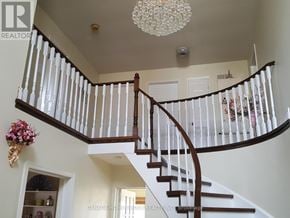 Mississauga (East Credit) apartment for rent - A staircase with a chandelier hanging from the ceiling.