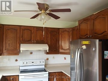 Mississauga (East Credit) apartment for rent - A kitchen with wooden cabinets and a stainless steel refrigerator.