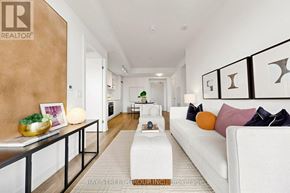 Toronto (Waterfront Communities) condo for rent - A living room with a white couch and a wooden table.