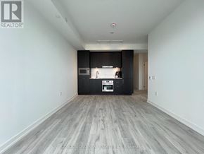 Toronto (Newtonbrook East) condo for rent - A spacious room with a kitchenette and a large window.