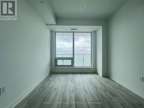 Toronto (Newtonbrook East) condo for rent - A room with a large window and wooden flooring.