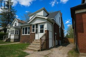 Hamilton (Westdale) apartment for rent - A house with a white door and a brick wall.