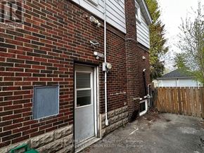 Hamilton (Westdale) apartment for rent - A red brick house with a white door and a window.