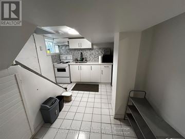 Hamilton (Westdale) apartment for rent - A kitchen with white cabinets and a white stove top oven.