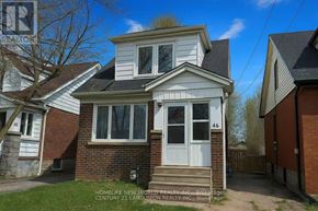 Hamilton (Westdale) apartment for rent - A two-story house with a white door and windows is for sale.