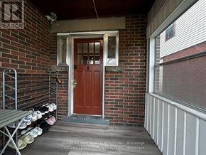 Hamilton (Westdale) apartment for rent - Shoes are lined up on a rack outside a door.