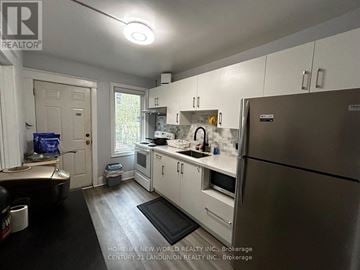 Hamilton (Westdale) apartment for rent - A kitchen with white cabinets and a stainless steel refrigerator.