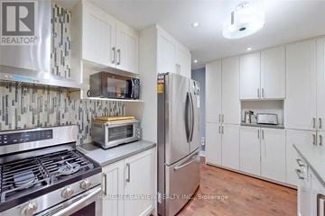 Toronto (West Hill) apartment for rent - A kitchen with white cabinets and a stove top oven.