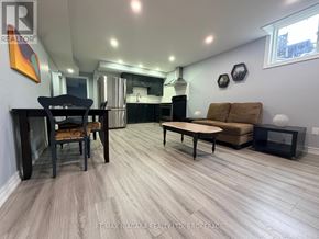 Niagara Falls (Forestview) apartment for rent - A living room with a couch, chair, and table.