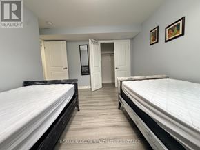 Niagara Falls (Forestview) apartment for rent - A bedroom with two beds and a television in the corner.