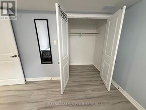 Niagara Falls (Forestview) apartment for rent - A room with a white door and a mirror on the wall.