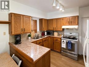 Vancouver apartment for rent - A kitchen with wooden cabinets and a granite countertop.
