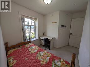 Vancouver apartment for rent - A bedroom with a bed, desk, and chair.