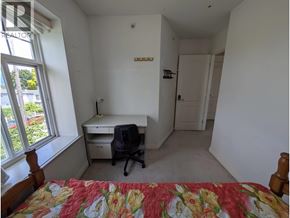 Vancouver apartment for rent - A bedroom with a bed, desk, and chair.