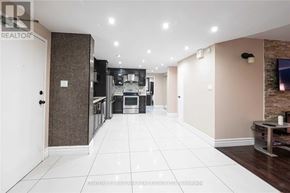 Toronto (Kingsview Village-The Westway) condo for rent - A spacious kitchen with a dining area and a living room with a brick wall.