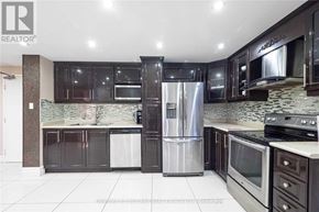 Toronto (Kingsview Village-The Westway) condo for rent - A modern kitchen with dark brown cabinets and stainless steel appliances.