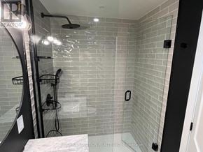 Toronto (Humber Heights) apartment for rent - A modern bathroom with a glass shower stall and a glass door.