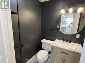 Toronto (Humber Heights) apartment for rent - A bathroom with a toilet, sink, and mirror.