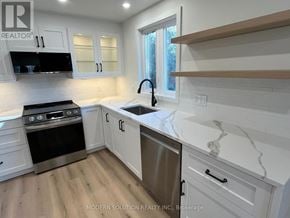 Toronto (Humber Heights) apartment for rent - A kitchen with white cabinets and a marble countertop.