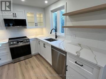 Toronto (Humber Heights) apartment for rent - A kitchen with white cabinets and a marble countertop.