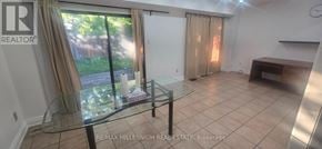 Brampton (Fletcher's West) apartment for rent - A glass table is in a white room with a sliding glass door.