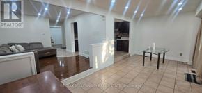 Brampton (Fletcher's West) apartment for rent - A spacious living room with a glass table and a couch.