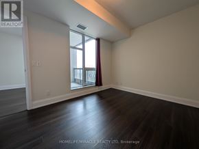 Toronto (High Park-Swansea) condo for rent - A room with wooden floors and a window with red curtains.