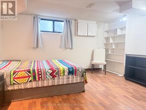 Toronto (Hillcrest Village) apartment for rent - A bedroom with a bed, a chair, and a window.