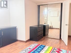 Toronto (Hillcrest Village) apartment for rent - A room with a black dresser and a mirror on the wall.
