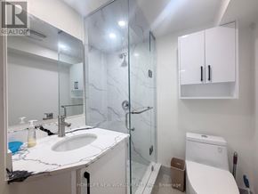 Toronto (Hillcrest Village) apartment for rent - A bathroom with a marble countertop and a walk-in shower.