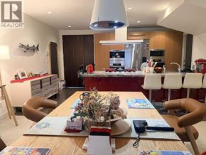 Vancouver townhouse for rent - A dining room with a table set for four and a view of the kitchen.