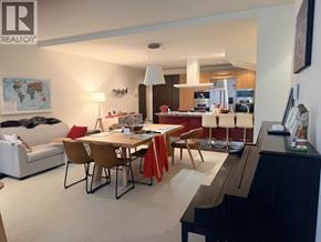Vancouver townhouse for rent - A living room with a piano and a dining table with chairs.