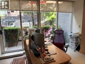 Vancouver townhouse for rent - A room with a desk, chair, and a window overlooking a garden.