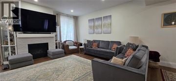 Ayr apartment for rent - A living room with a grey couch and a fireplace.