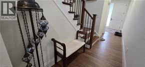 Ayr apartment for rent - A staircase with a metal railing and a wooden handrail.
