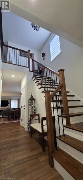 Ayr apartment for rent - A wooden staircase with a metal railing and a skylight above.