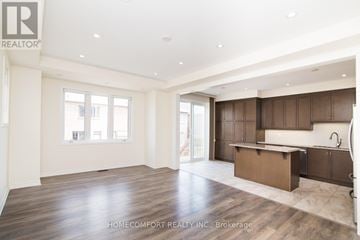 Richmond Hill townhouse for rent - A spacious kitchen with wooden cabinets and a large island.