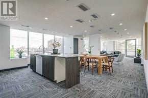 Toronto (Bayview Woods-Steeles) condo for rent - A modern office space with a reception desk and a conference room.