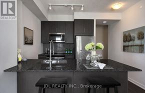 Mississauga (City Centre) condo for rent - A modern kitchen with granite countertops and stainless steel appliances.