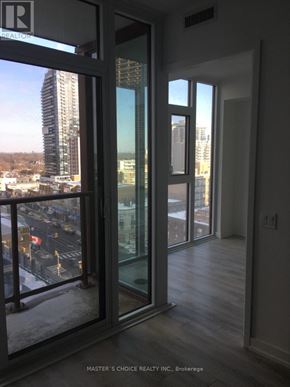 Toronto (Yonge-Eglinton) condo for rent - A view of a city from a window in a room with glass doors.