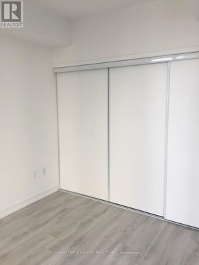 Toronto (Yonge-Eglinton) condo for rent - A room with white walls and a sliding door.