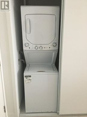 Toronto (Yonge-Eglinton) condo for rent - A white dryer is sitting in a white closet.