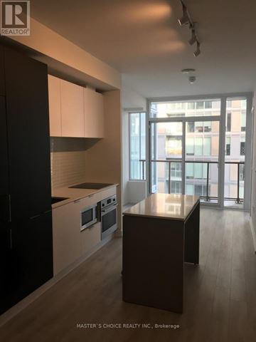 Toronto (Yonge-Eglinton) condo for rent - A kitchen with black cabinets and a wooden island.
